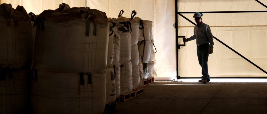 FILE PHOTO: A worker closes a warehouse of lithium carbonate processed from the Rockwood Lithium mine on the Atacama salt flat