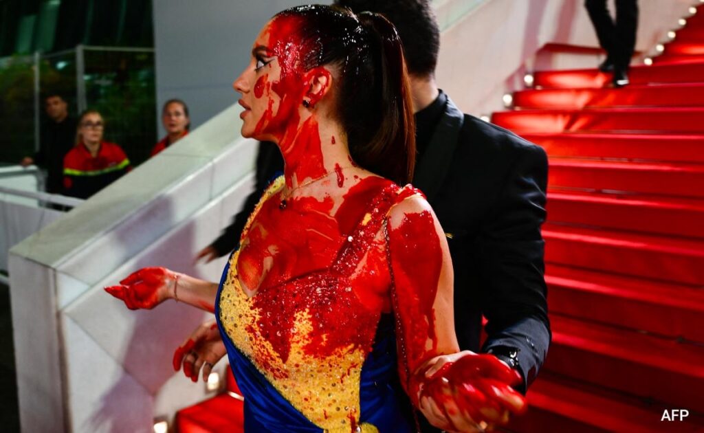 Protester Dressed In Ukrainian Colours Covers Herself In Fake Blood On Cannes Red Carpet