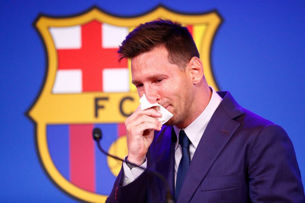 Lionel Messi reacts to Barcelona fans chanting his name.