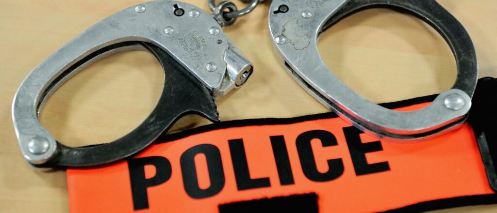 FRANCE-POLICE-HANDCUFFS-BADGE