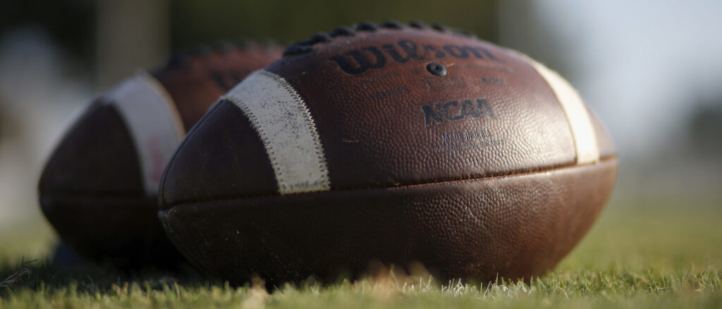 Footballs are seen on the turf before the high school football game between the East Bernard Brahmas and the Edna Cowboys on August 28, 2020 in East Bernard, Texas. (Photo by Tim Warner/Getty Images)