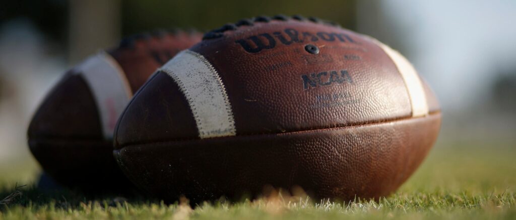 Footballs are seen on the turf before the high school football game between the East Bernard Brahmas and the Edna Cowboys on August 28, 2020 in East Bernard, Texas. (Photo by Tim Warner/Getty Images)