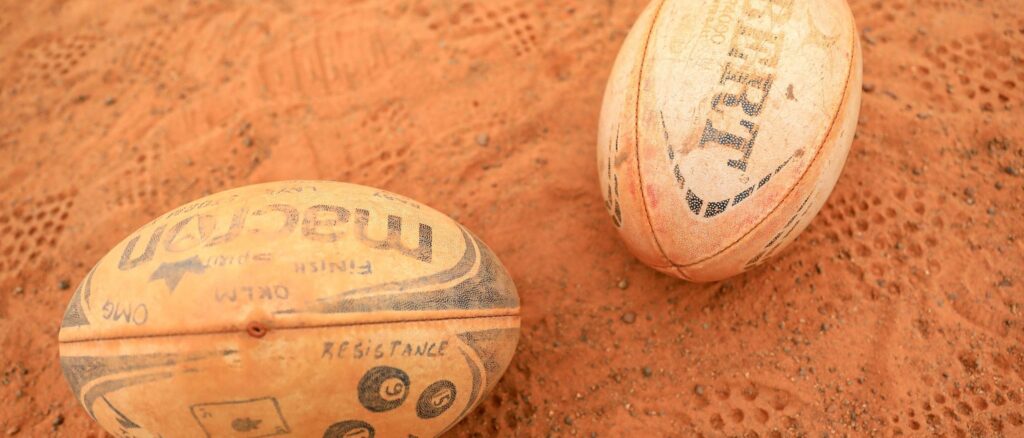 Rugby balls are seen on a field during a Fon Dream Academy training session in Yaounde on July 12, 2022. - In the land of the round ball, where Samuel Eto