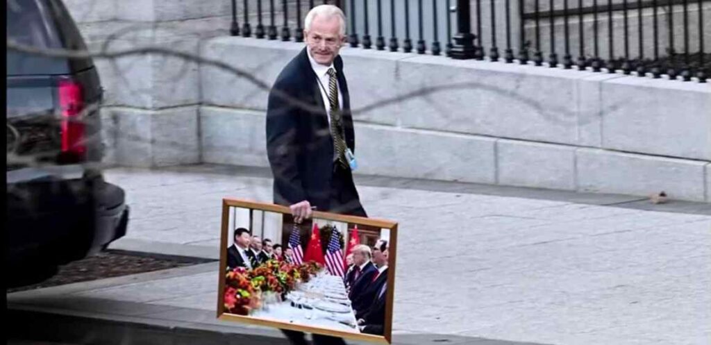 Peter Navarro takes a painting of Trump and Xi