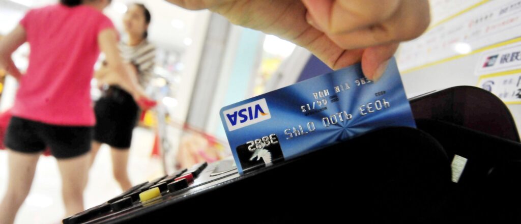 A Chinese man swipes his credit card in