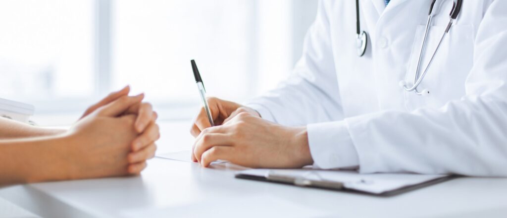 Close,Up,Of,Patient,And,Doctor,Taking,Notes