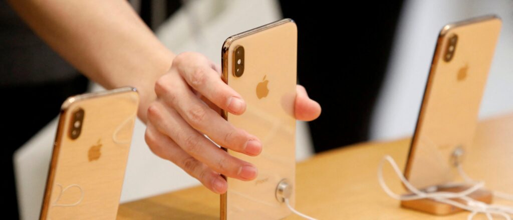 FILE PHOTO: People look at iPhones at the World Trade Center Apple Store during a Black Friday sales event in Manhattan, New York City