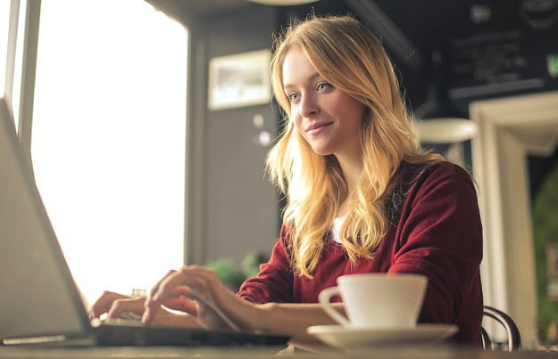 Short, Positive and Inspirational Sayings A focused woman working on her laptop.