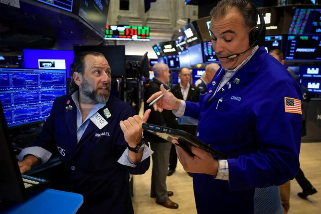 Stocks edge lower as dollar rises to one-year high