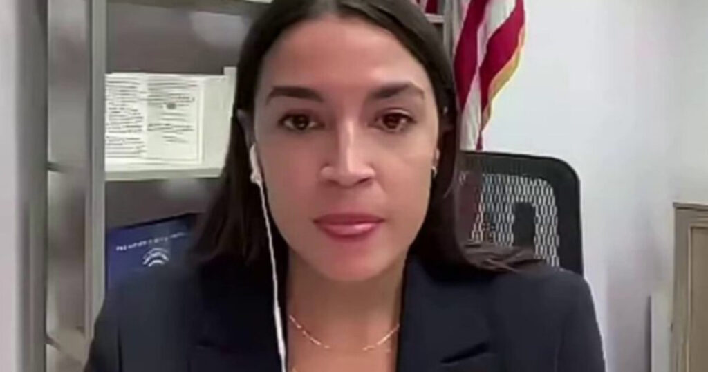 AOC Gets TORCHED After Getting Caught Spreading This Huge Lie About the U.S. House’s $1 Trillion Defense Bill Congresswoman speaking during a virtual meeting, with a background featuring awards and an American flag.
