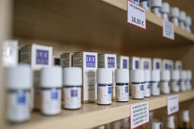 How To Evaluate Natural Wellness Products Carefully Rows of small remedy bottles with price tags on wooden shop shelves