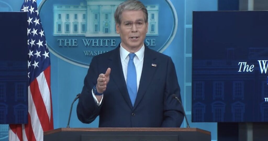 Transgender Defendant Convicted of Crimes Connected to Attempted Assassination of Treasury Secretary Bessent Sentenced to 6 Years in Federal Prison Press briefing at the White House featuring a speaker addressing the audience with an American flag in the background.