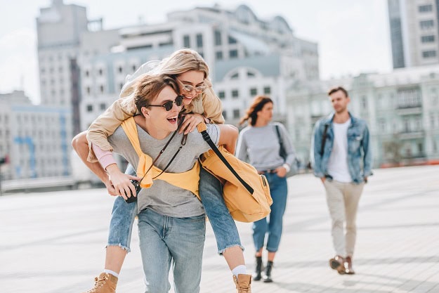 100 Funny Saturday Quotes for a Happy, Hilarious and Relaxing Day Friends outside having fun in a city area.