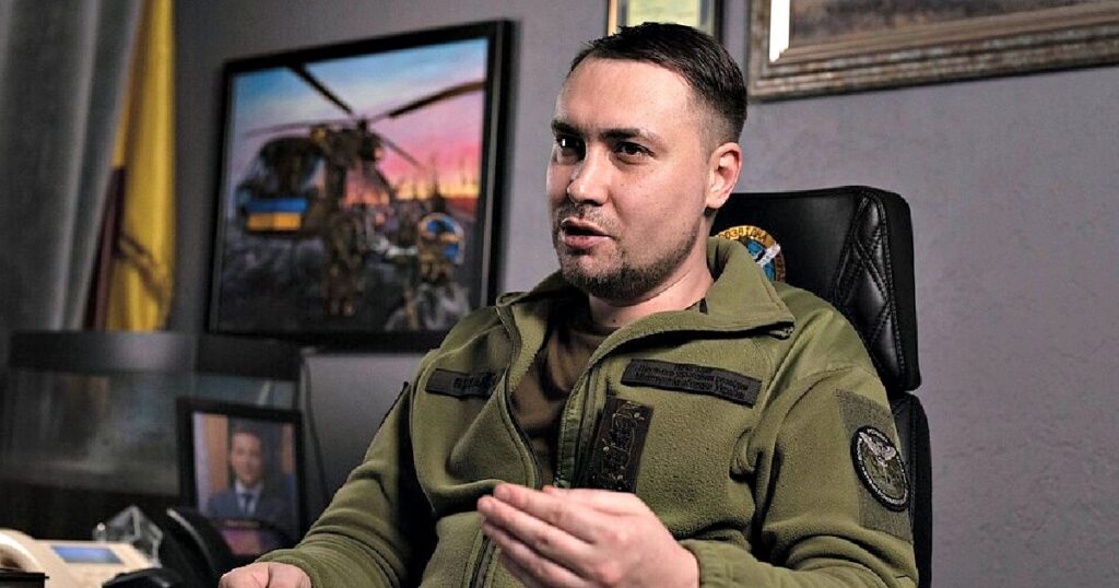 ANOTHER ONE? Zelensky’s Chief of Staff Budanov Reportedly Being Probed by Ukrainian Anti-Corruption Agencies * The Gateway Pundit * by Paul Serran Military official discussing strategy in an office, featuring a helicopter painting and framed photographs in the background.