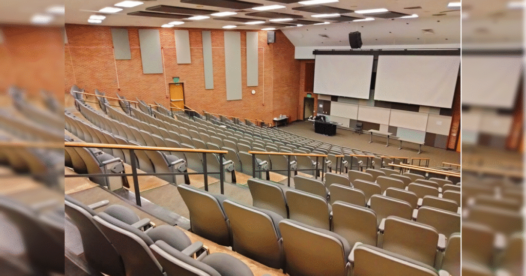 Professor Punished by University for Parodying Land Acknowledgments Gets Payday * The Gateway Pundit * by Margaret Flavin A spacious lecture hall featuring tiered seating, large projection screens, and a central teaching area, suitable for educational presentations and classes.